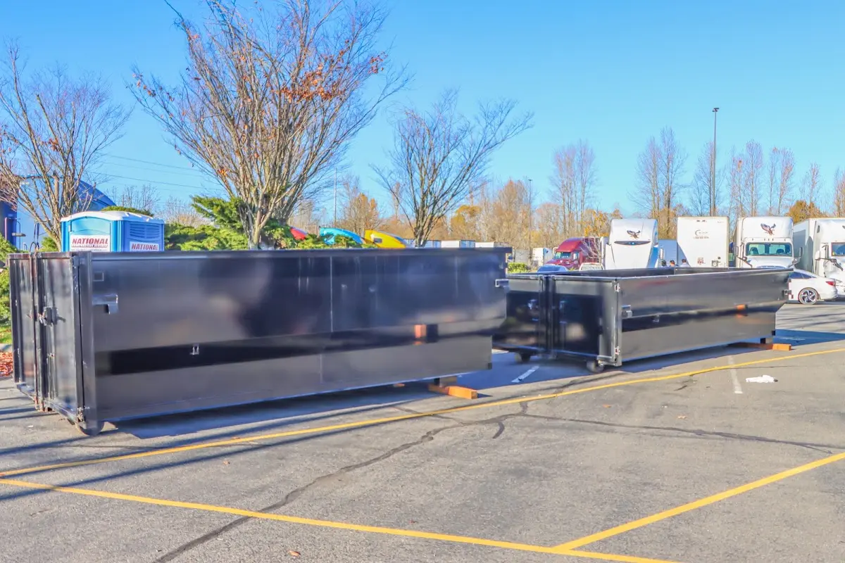 Professional dumpster rental service with roll-off container on residential driveway in Cheverly